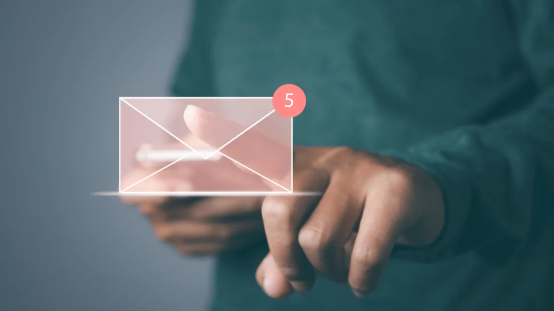 A hand tapping a glowing email envelope icon showing five new messages