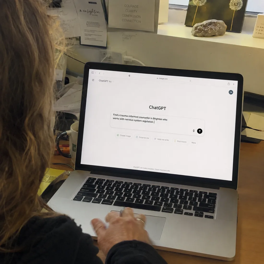 A practitioner typing a request into ChatGPT to find a trauma-informed counsellor who works with nervous system regulation