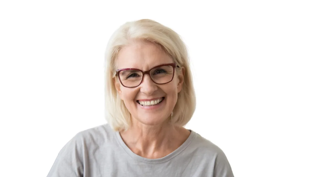 A smiling woman with glasses in a grey t-shirt against a white background