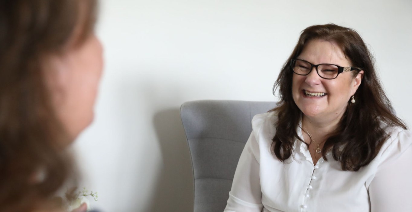 Carrie Wallis laughing with a client during a session