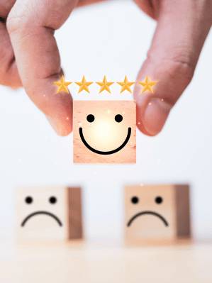 A hand choosing a smiling face with five stars over two sad faces