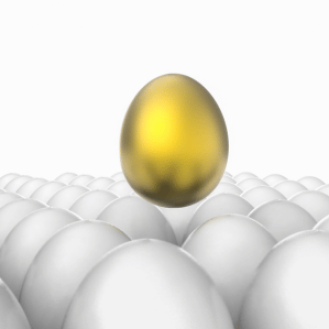 A golden egg standing out among white eggs